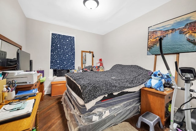 bedroom featuring dark wood finished floors