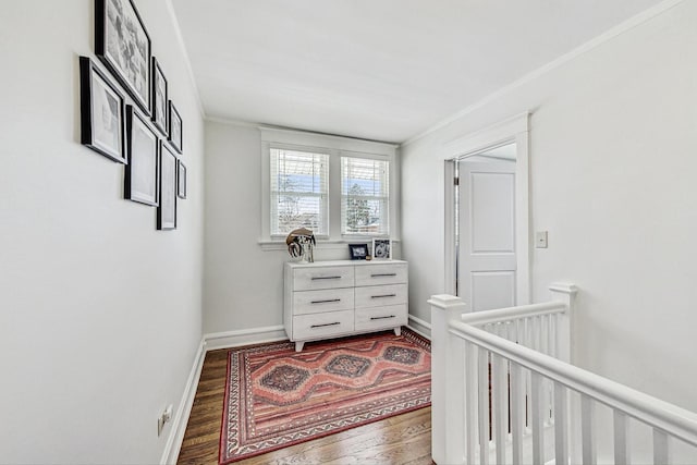 hall featuring crown molding, wood finished floors, an upstairs landing, and baseboards