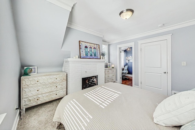 carpeted bedroom featuring ornamental molding, a brick fireplace, and baseboards