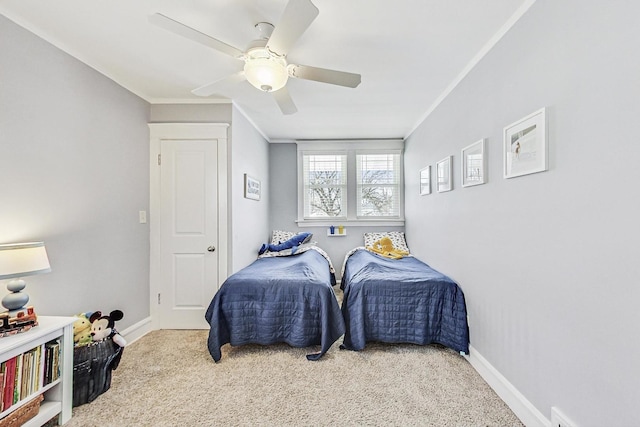 carpeted bedroom with baseboards, ornamental molding, and ceiling fan