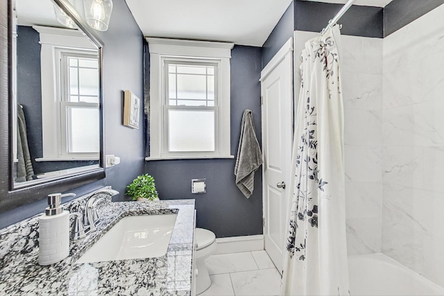 full bathroom with shower / bath combo, baseboards, toilet, marble finish floor, and vanity