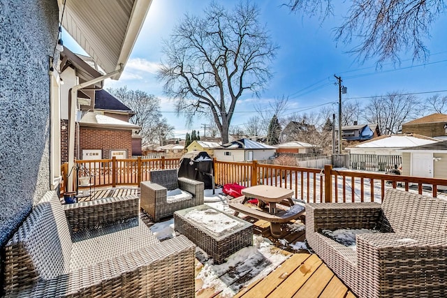 wooden deck featuring outdoor lounge area, fence, and a residential view