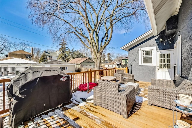 wooden deck featuring area for grilling, fence, and a residential view