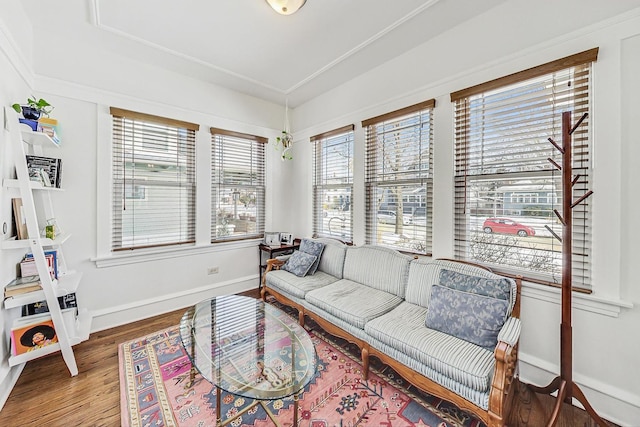 living area with wood finished floors and baseboards