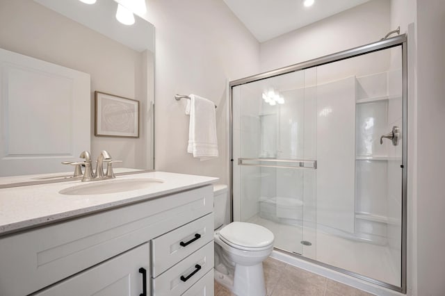 bathroom featuring toilet, a shower stall, vanity, and tile patterned floors