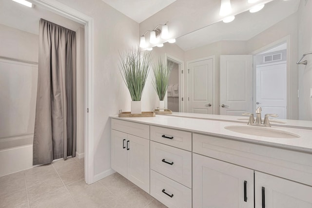 bathroom with tile patterned flooring, shower / tub combo, vanity, visible vents, and baseboards