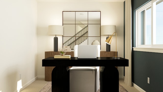 home office with baseboards and light colored carpet