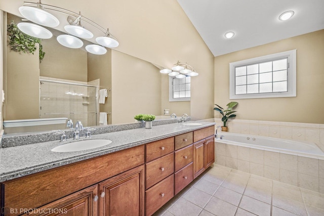 full bathroom with lofted ceiling, double vanity, a sink, and tile patterned floors