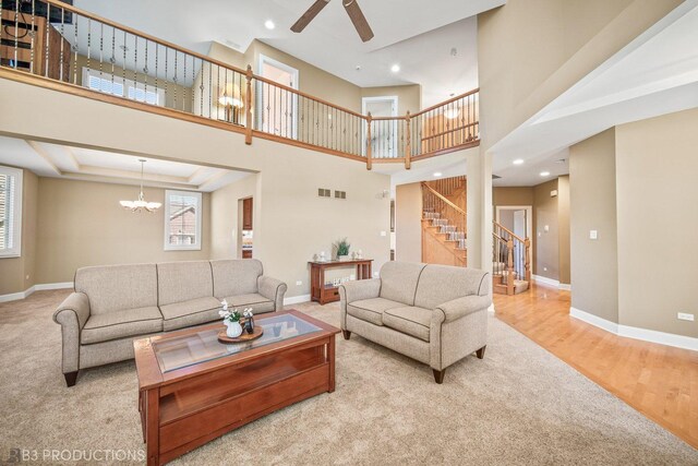 living room with stairway, a wealth of natural light, and baseboards