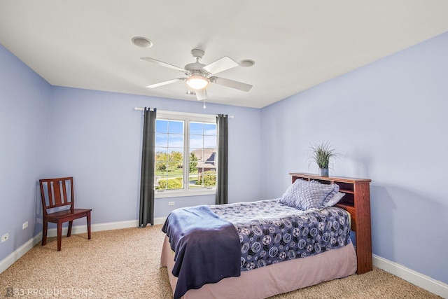 bedroom with baseboards, a ceiling fan, and light colored carpet