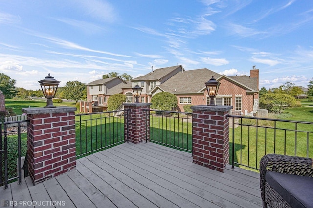 wooden deck featuring a yard and a residential view