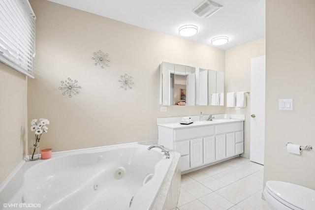 full bathroom featuring visible vents, toilet, vanity, a jetted tub, and tile patterned floors