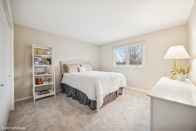 carpeted bedroom featuring baseboards