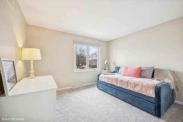 carpeted bedroom featuring visible vents and baseboards