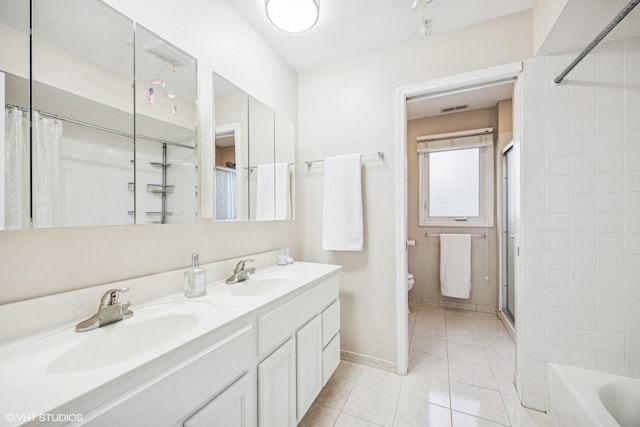 bathroom with tile patterned floors, a sink, toilet, and a shower with curtain