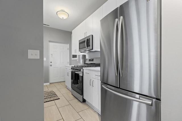 kitchen featuring appliances with stainless steel finishes, light countertops, visible vents, and white cabinetry