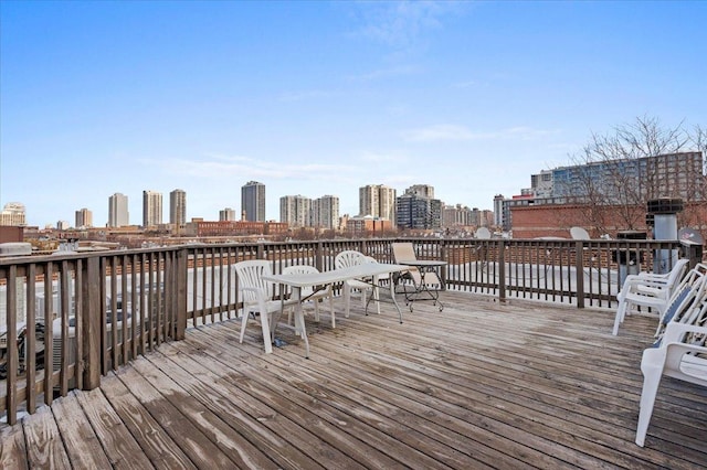 wooden terrace featuring a view of city