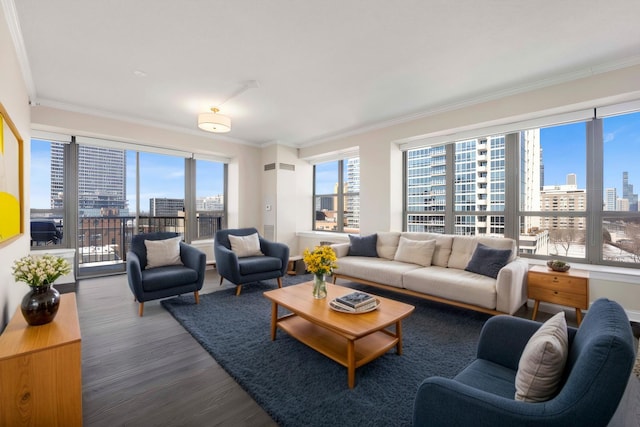 living room with a view of city, ornamental molding, and wood finished floors