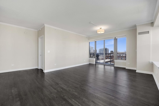 empty room with a view of city, visible vents, dark wood-type flooring, and ornamental molding