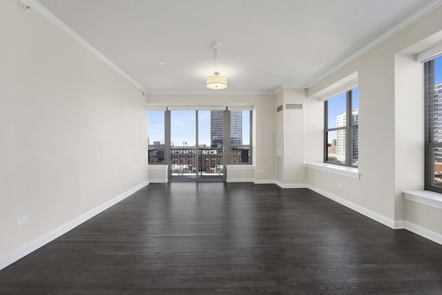 unfurnished room with a healthy amount of sunlight, baseboards, dark wood-style flooring, and crown molding