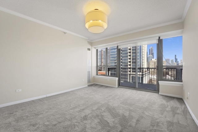 unfurnished room featuring plenty of natural light, ornamental molding, and a city view