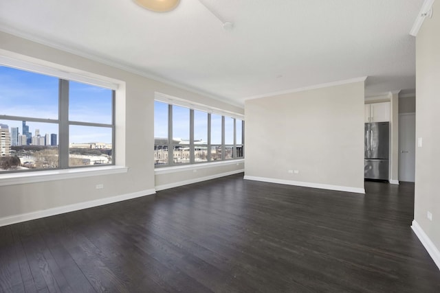 unfurnished room featuring dark wood-type flooring, a view of city, crown molding, and baseboards