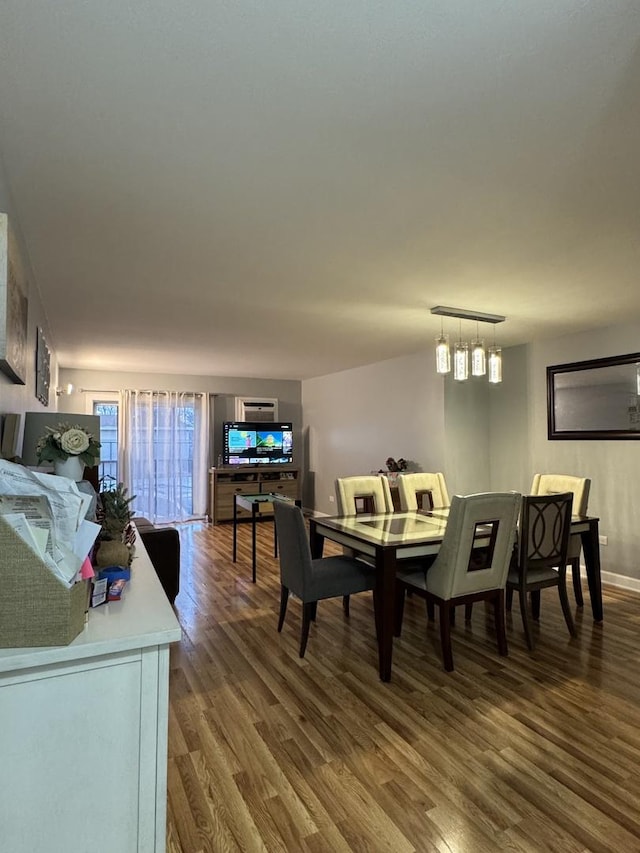 dining room featuring baseboards and wood finished floors