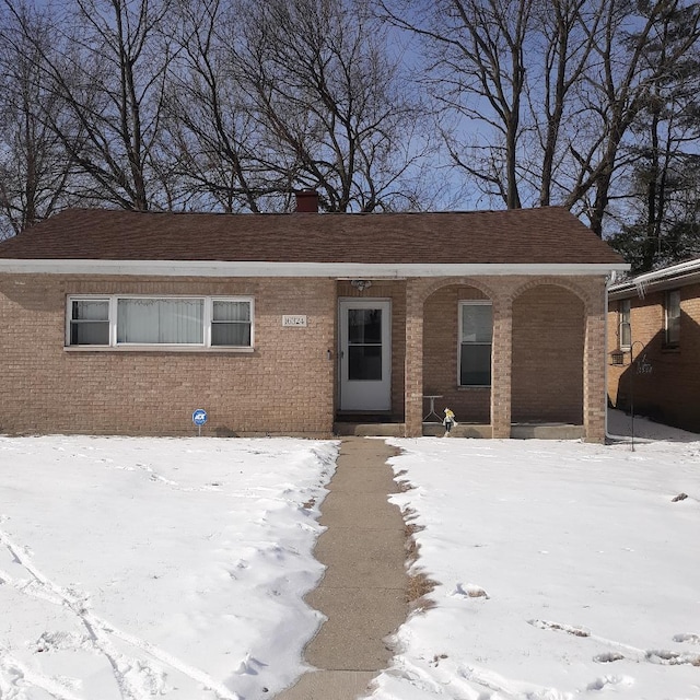 single story home featuring brick siding