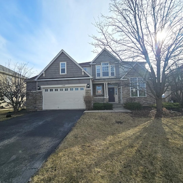 view of front facade featuring aphalt driveway and stone siding