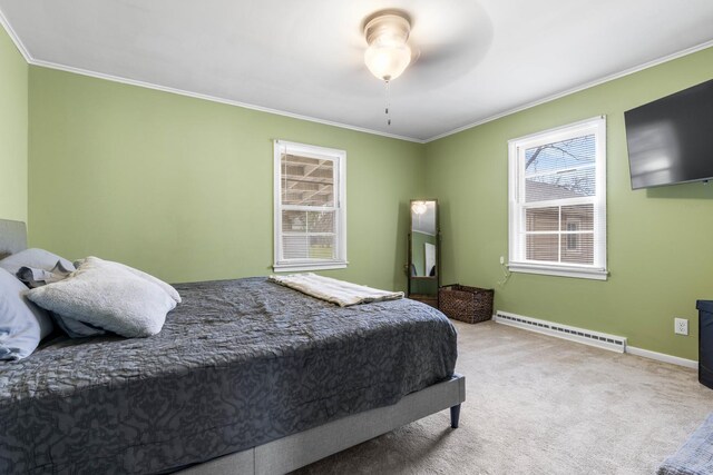 bedroom with a baseboard heating unit, crown molding, baseboards, and light colored carpet