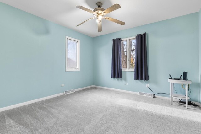 unfurnished room with a ceiling fan, carpet flooring, visible vents, and baseboards