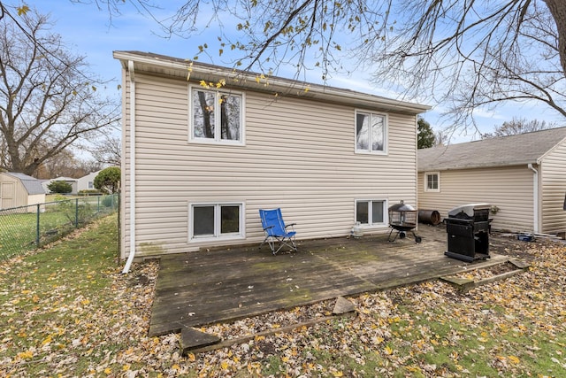 back of house featuring a deck and fence