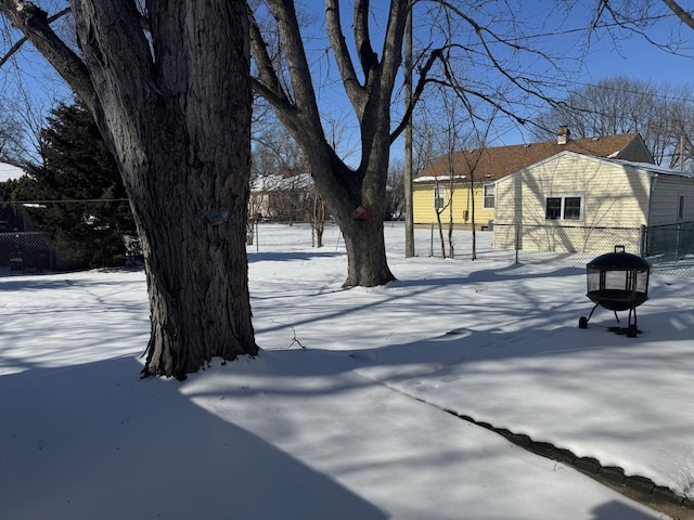 snowy yard with fence