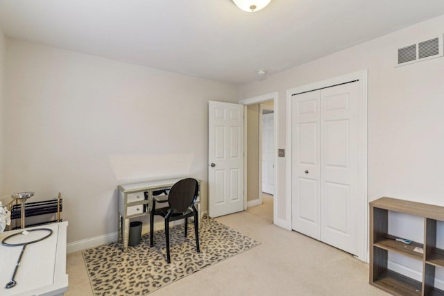 office space with visible vents, light carpet, and baseboards