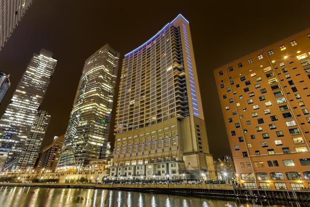 property at night featuring a water view and a view of city lights