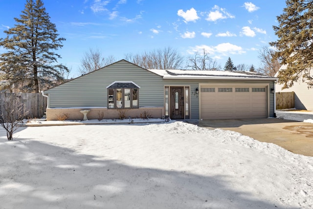 view of front of home featuring a garage, driveway, and fence