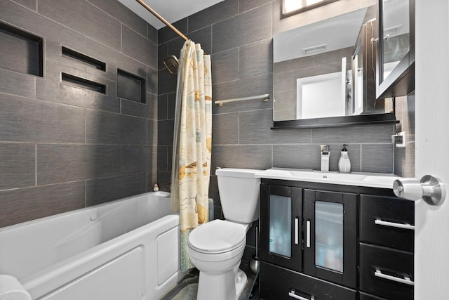 bathroom with tile walls, decorative backsplash, shower / bath combo with shower curtain, toilet, and vanity