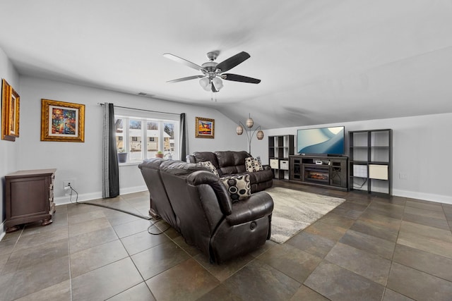 living room with a ceiling fan, visible vents, vaulted ceiling, and baseboards