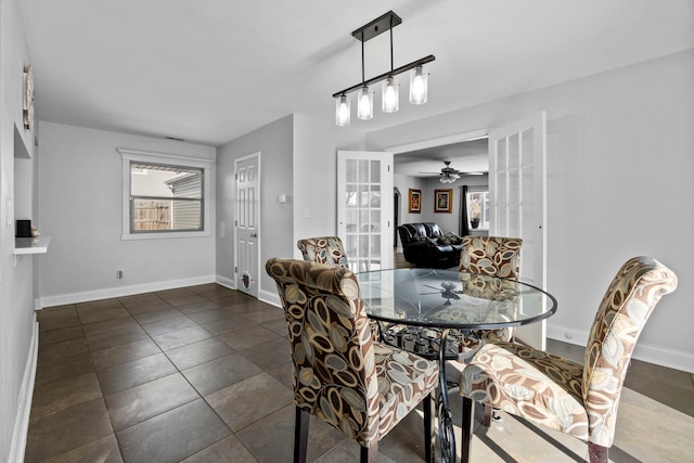 dining area featuring french doors, plenty of natural light, and baseboards