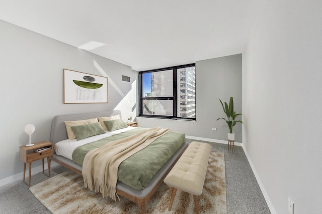 carpeted bedroom with visible vents and baseboards