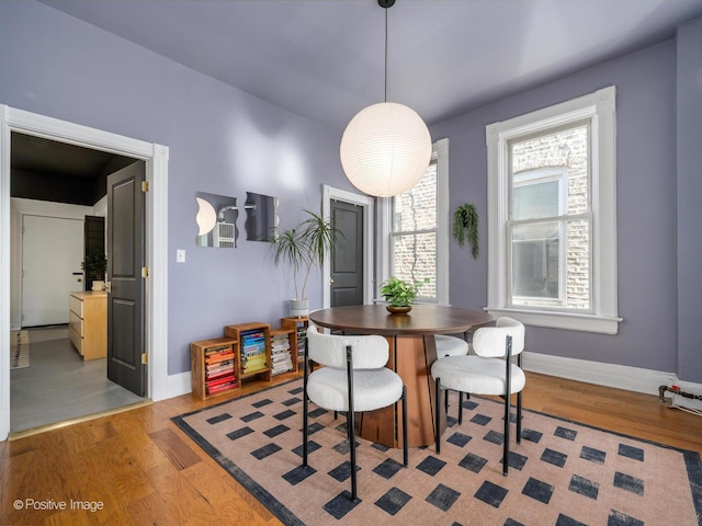 dining room with light wood finished floors and baseboards