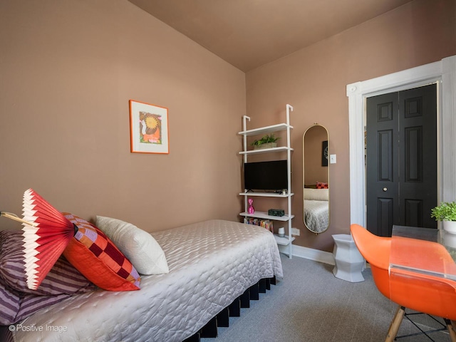 bedroom featuring carpet flooring and baseboards