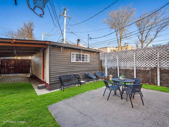 view of patio with outdoor dining space and fence