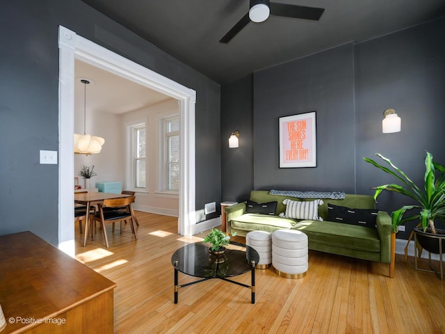 sitting room featuring ceiling fan, baseboards, and wood finished floors