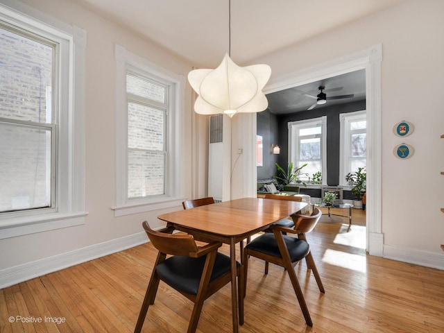 dining area featuring baseboards and light wood-style floors