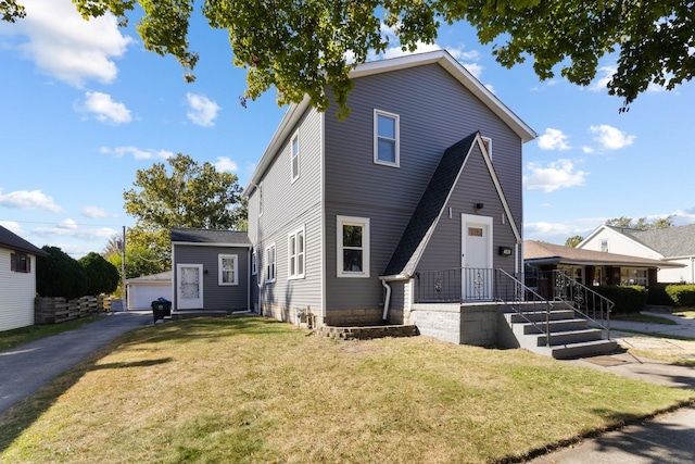 view of front of property featuring a front yard and an outdoor structure