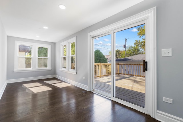 doorway with recessed lighting, baseboards, and wood finished floors