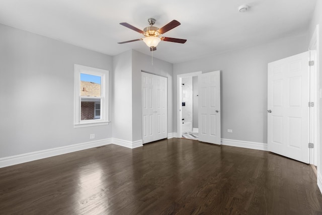 unfurnished bedroom featuring a closet, a ceiling fan, baseboards, and dark wood-style flooring