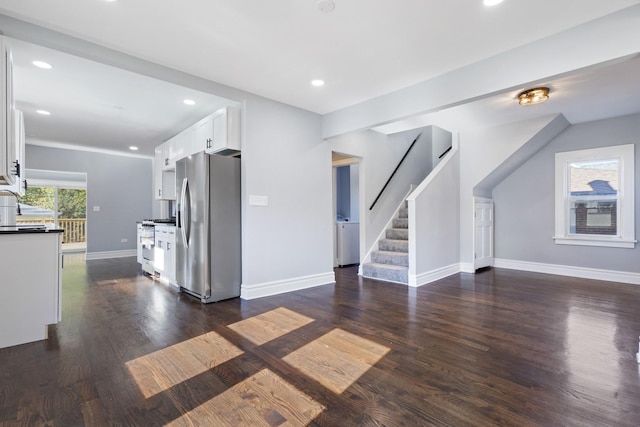 interior space featuring baseboards, stairs, recessed lighting, washer / dryer, and dark wood-style floors