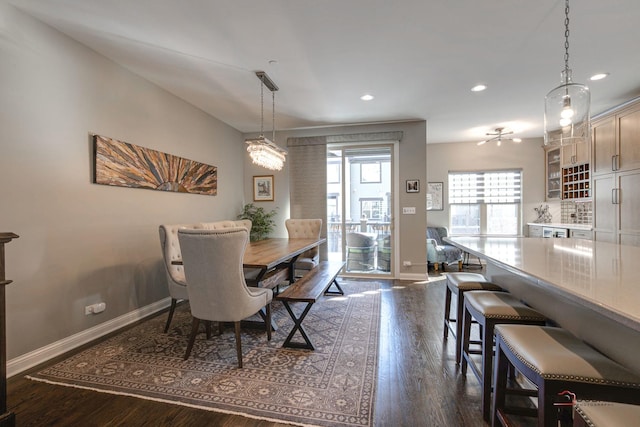 dining room with recessed lighting, baseboards, and dark wood-style flooring